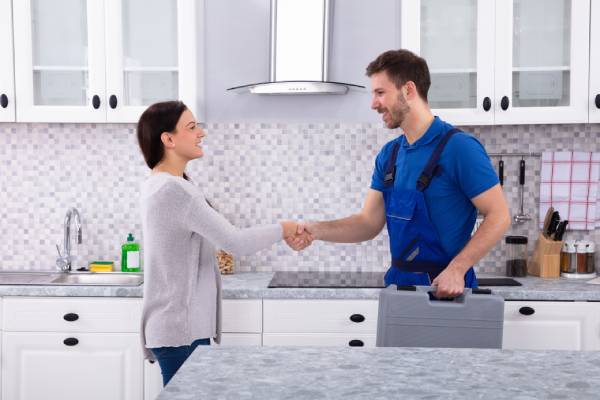 Technician shaking hands with home resident