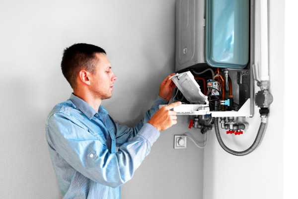 Frog Air Technician performing maintenance on A Tennessee Residential heater