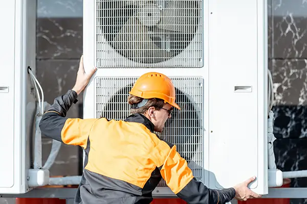 Technician installing a residential heat pump in Tennessee